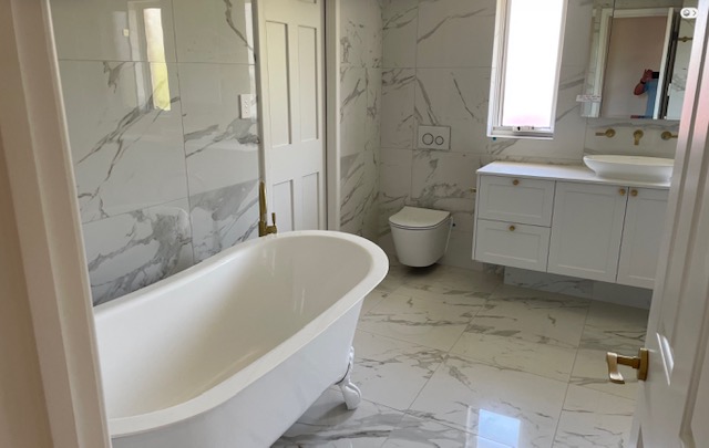 Clawfoot bath with marble-look tiles
