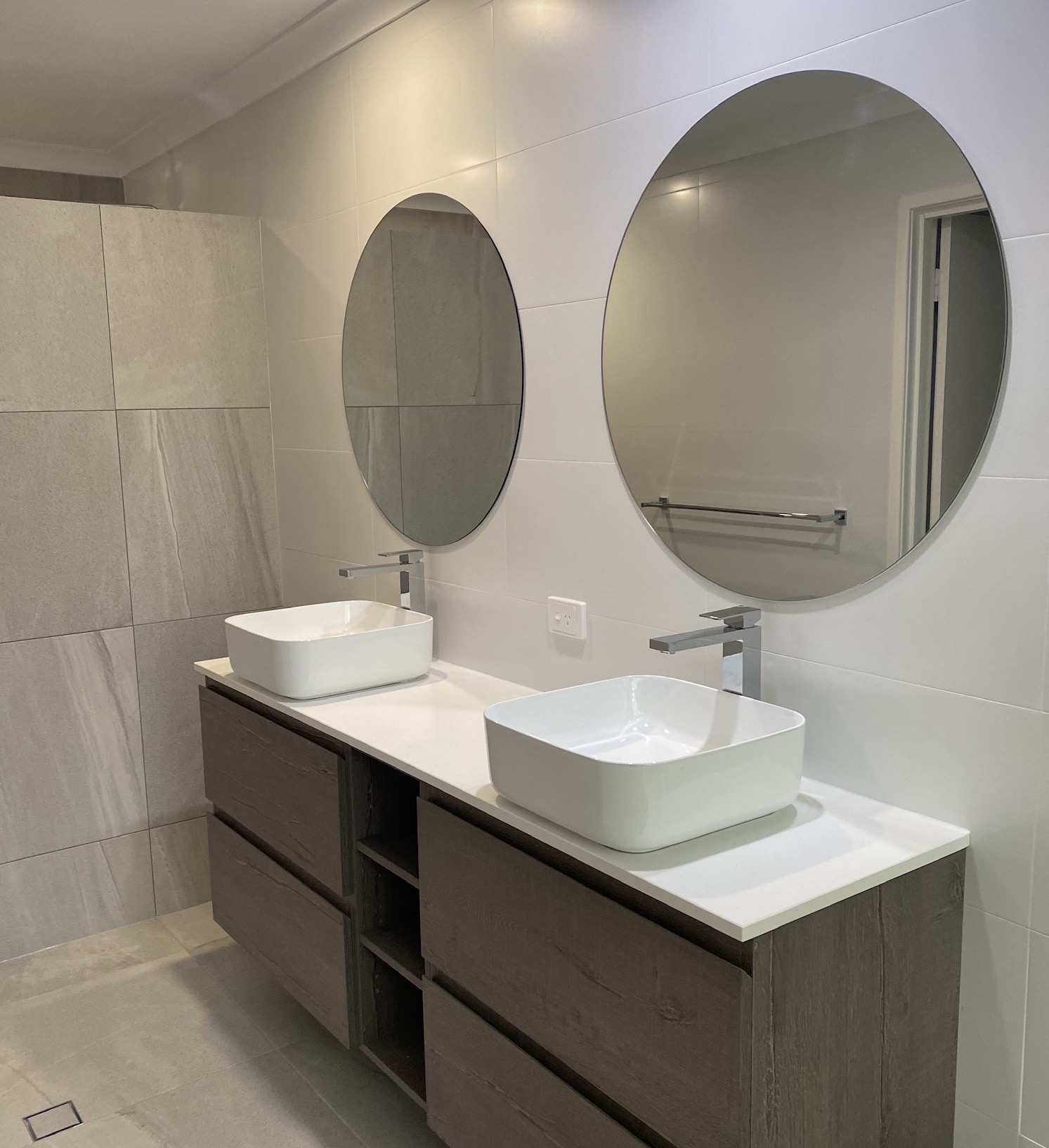 Timber-look double vanity with round mirrors