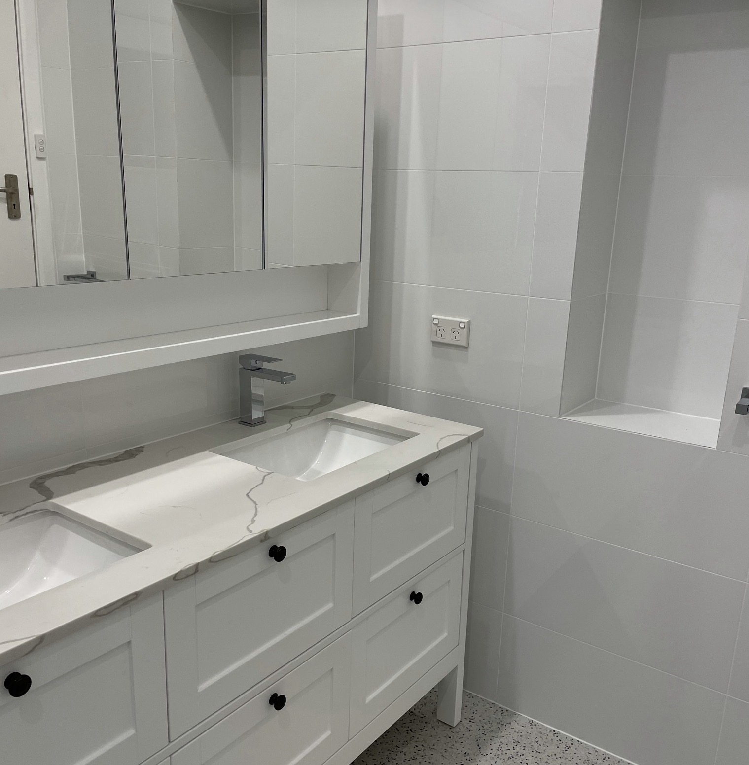 White shaker vanity with marble-look top