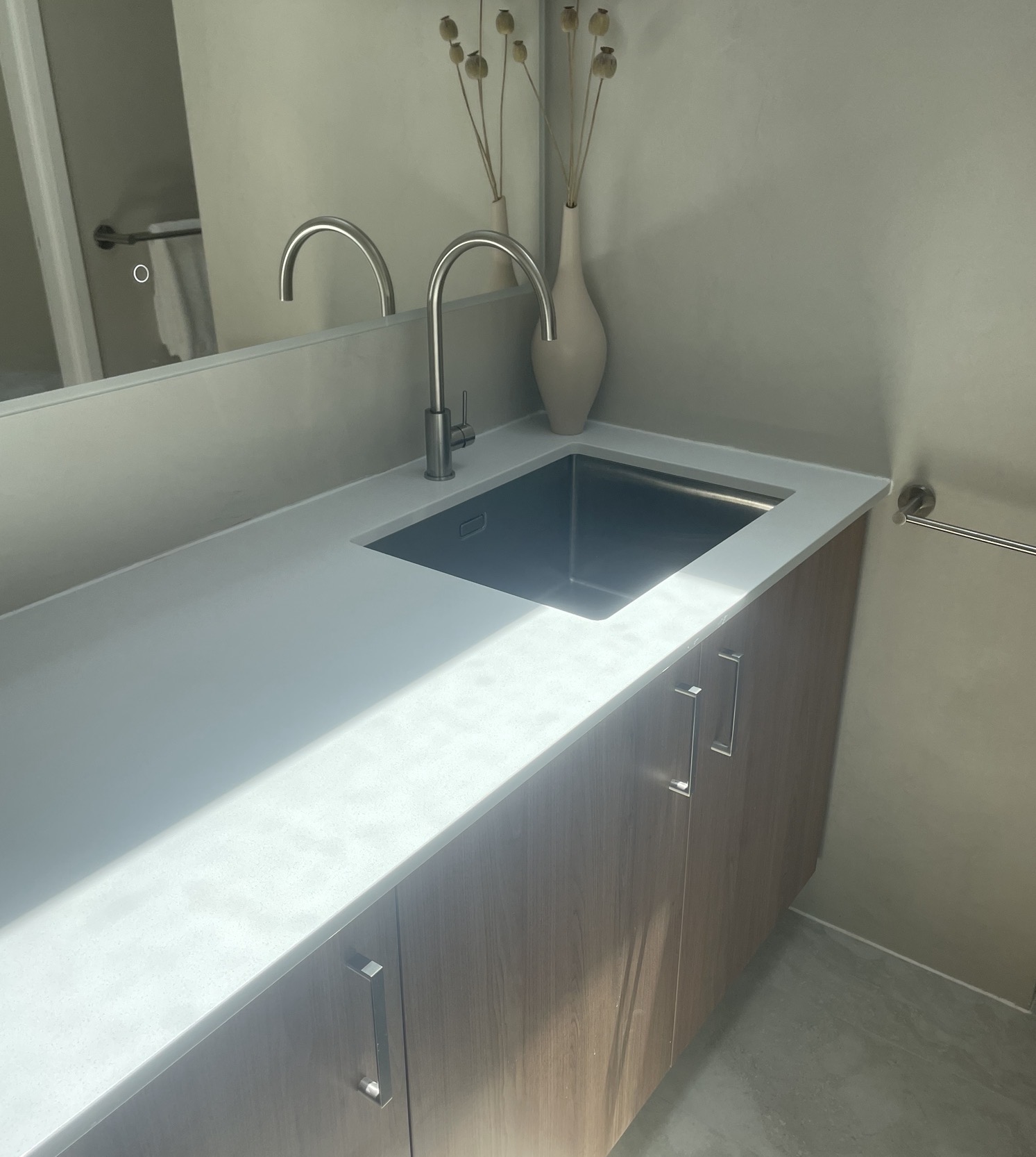 Steel sink vanity with timber-look cabinetry