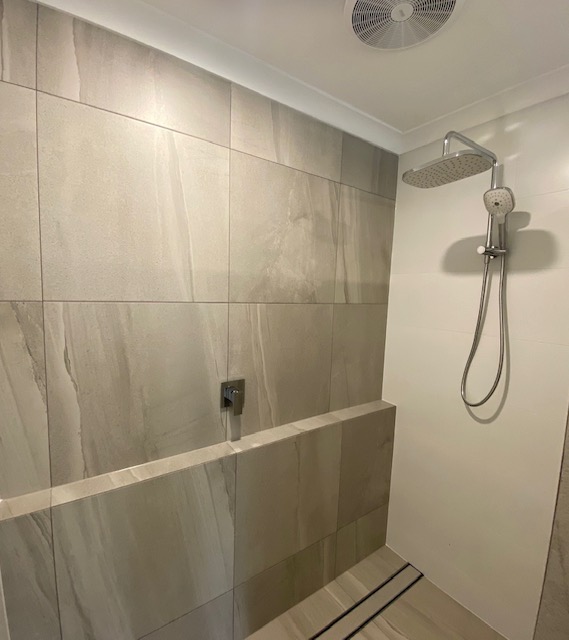 Walk-in shower with linear drain